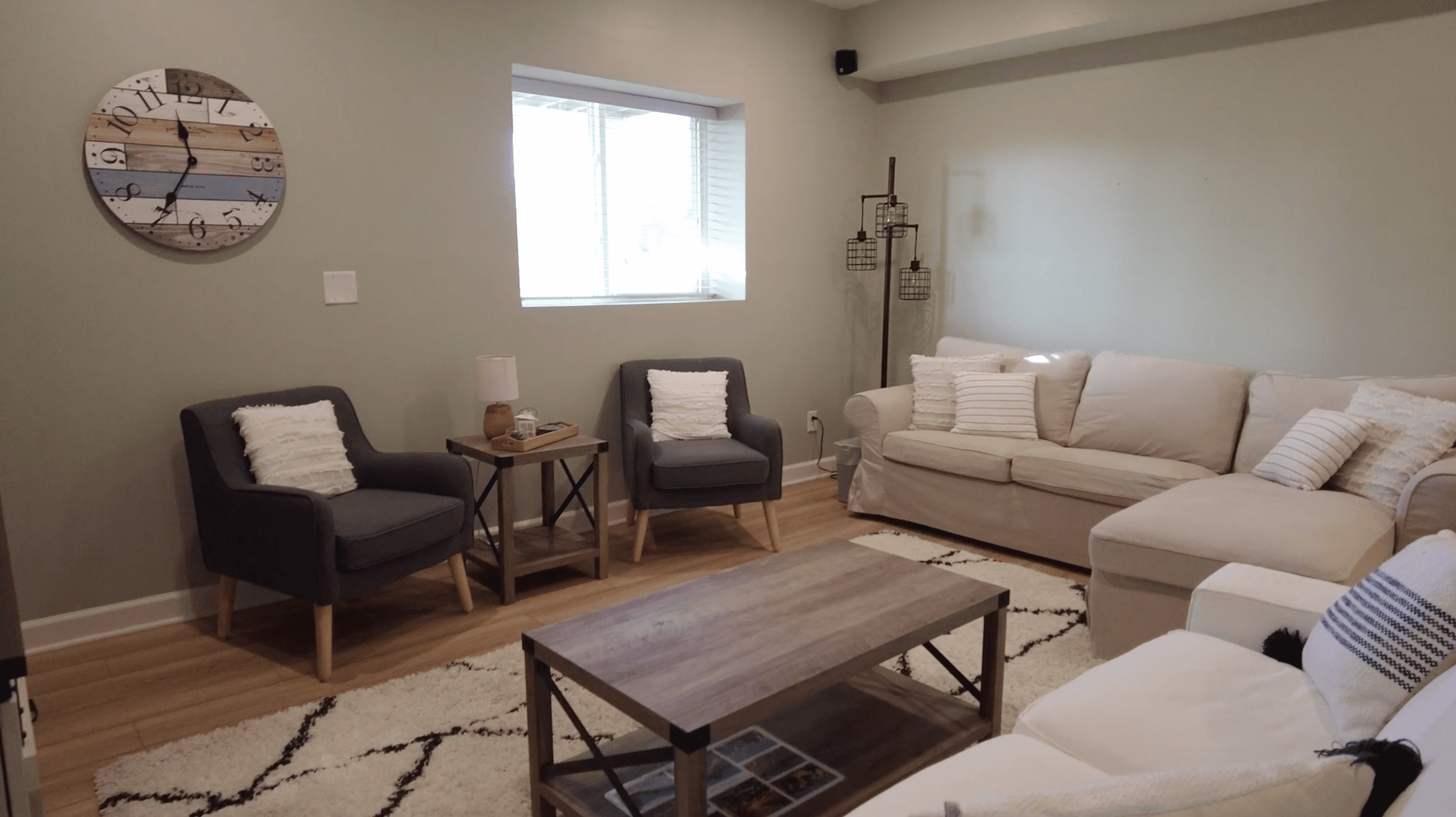 Finished lower-level living room with built-in millwork and warm lighting.
