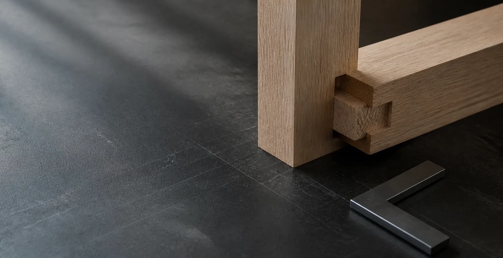 Close study of a fitted white-oak mortise-and-tenon timber joint.